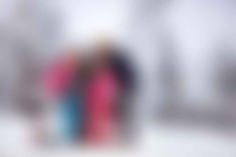 A group of friends enjoying a budget ski trip in Colorado, laughing and making memories on the snowy slopes.